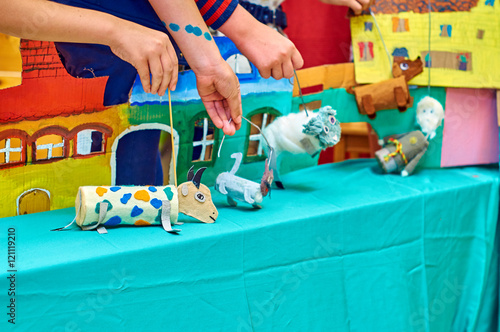 фотографія Children showing puppet show with self-made dolls