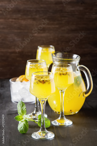 Alcoholic cocktail with fresh passion fruit with mint and ice. D