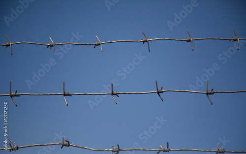 Barbed wire against the sky.