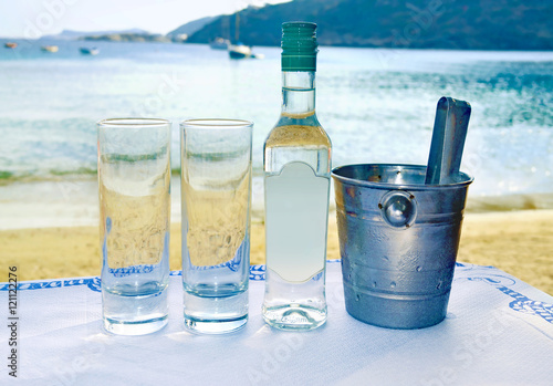greek ouzo at a tavern in front of the sea