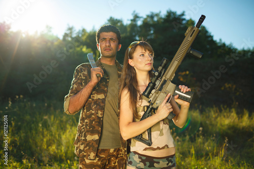 White girl and an Arab man in camouflage with a weapon in the ha