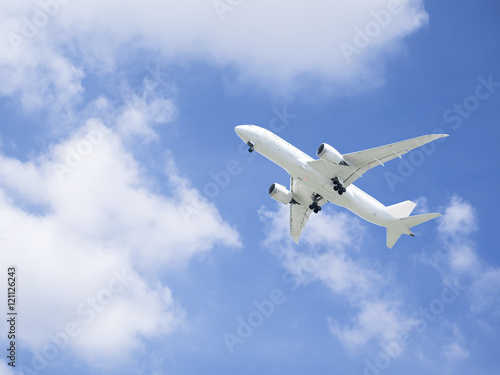 Airplane flying under blue sky 1