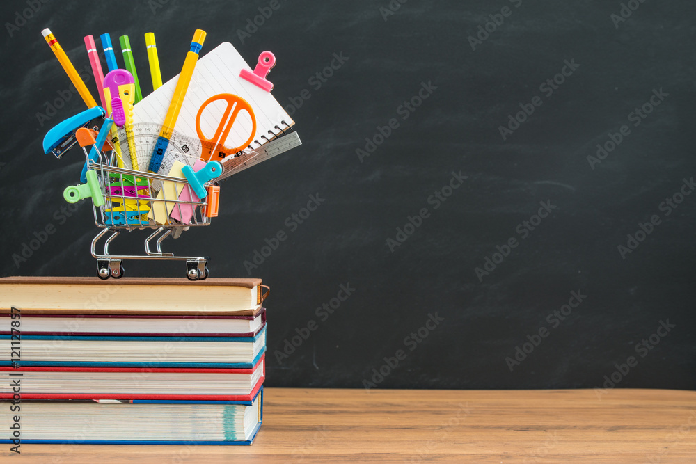 Colorful back to school supplies in front of chalkboard Colorful back to school supplies in front of chalkboard