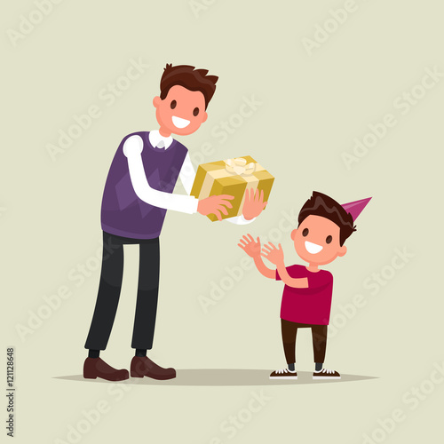 Children's birthday. The father gives his son a gift for his bir