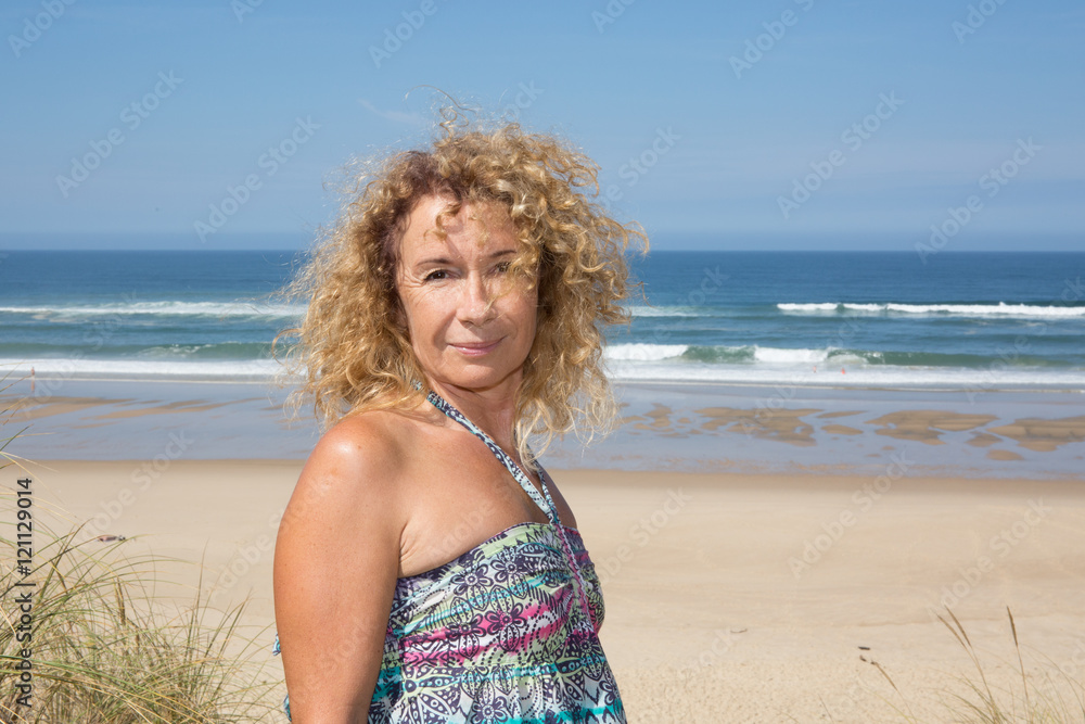 Tanned healthy middle aged woman with dress having fun. Tanned healthy middle aged woman with dress having fun.