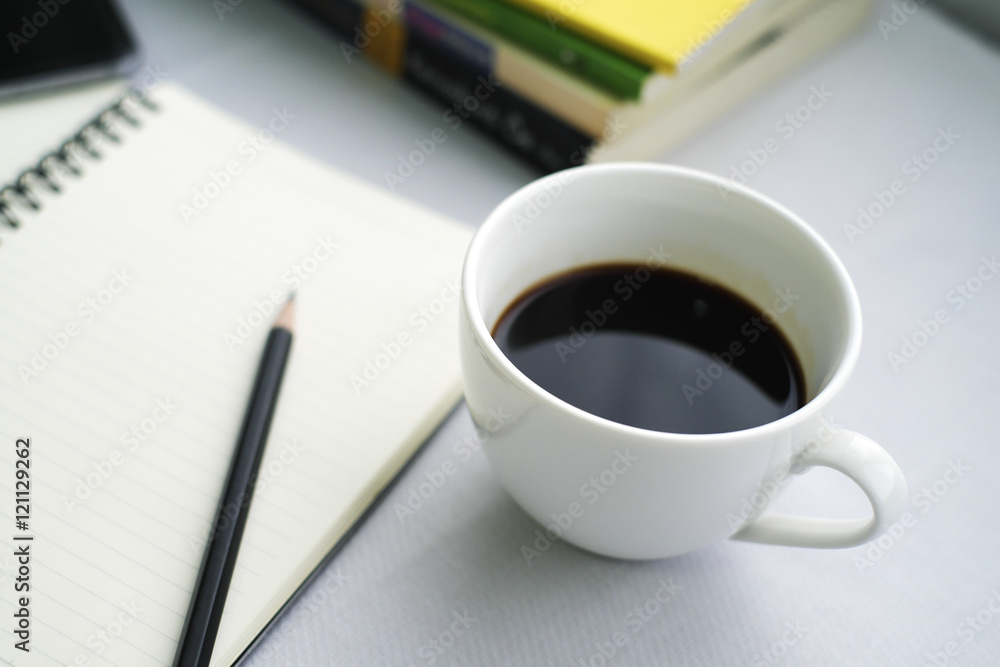 Coffee in white cup with Journal book and pencil Coffee in white cup with Journal book and pencil