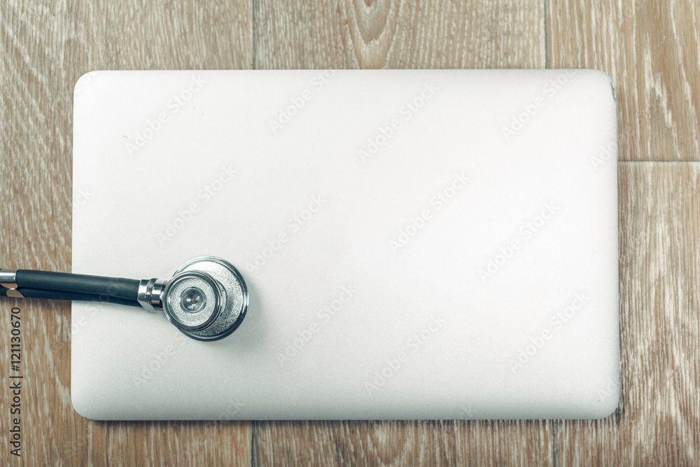 Stethoscope on laptop, close-up Stethoscope on laptop, close-up