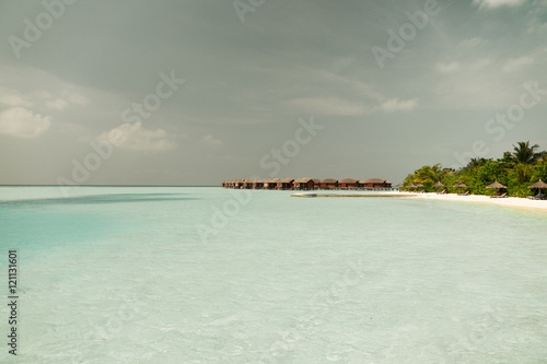 bungalow huts in sea water on exotic resort beach © Syda Productions