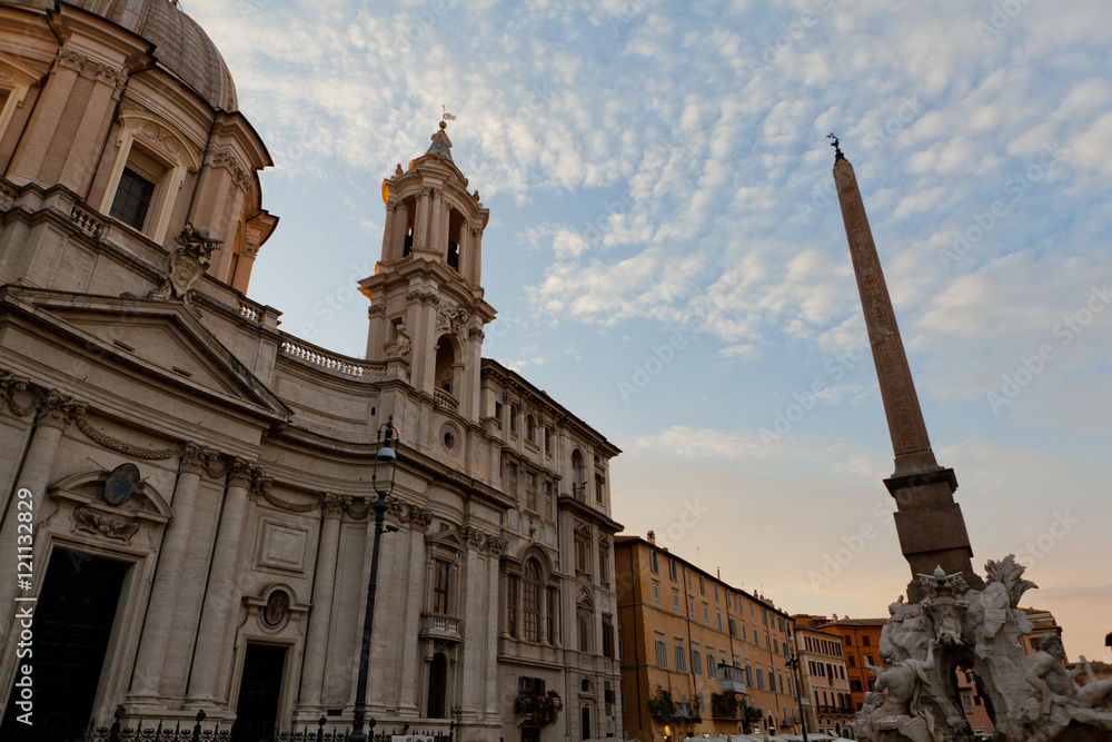 High spire raises to the sky before a cathedral in Rome