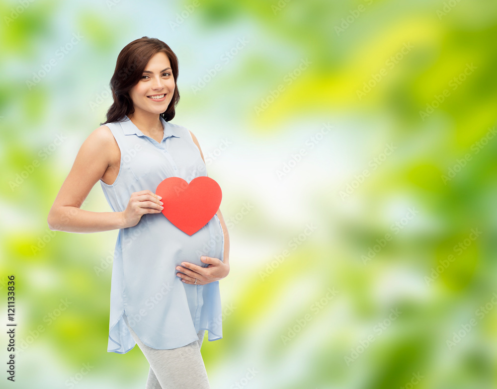 happy pregnant woman with red heart touching belly happy pregnant woman with red heart touching belly