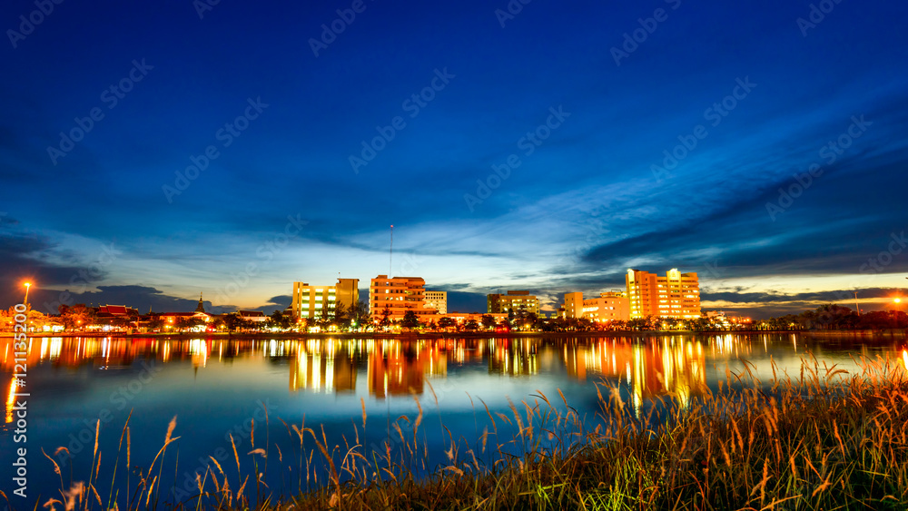 city at night with reflection of skyline in the lake