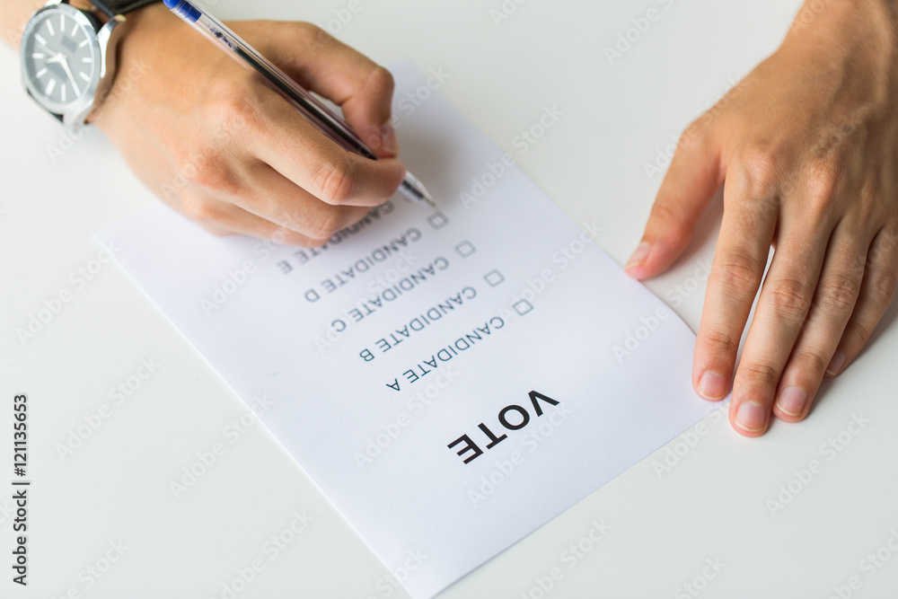 close up of hands with vote or ballot on election close up of hands with vote or ballot on election