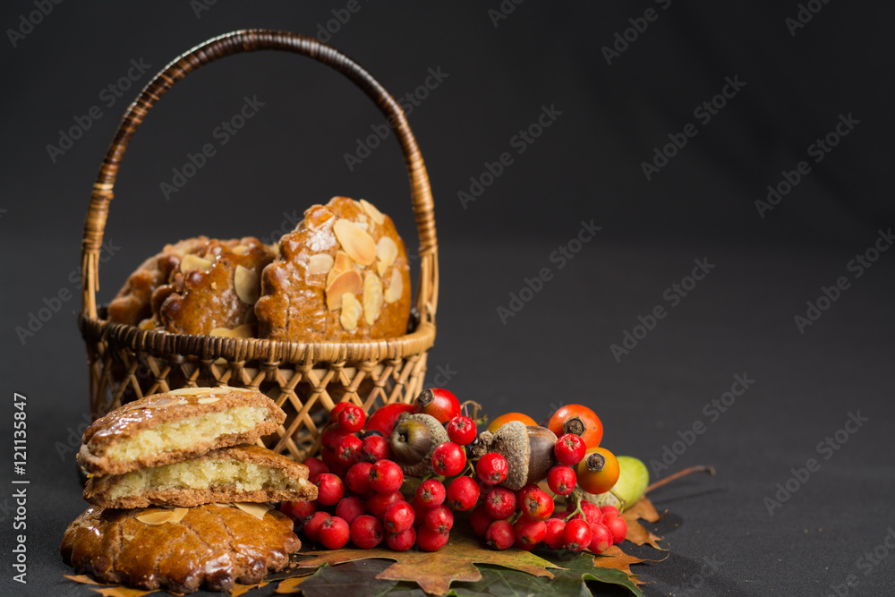 Typical Dutch filled spicy  cookies with almonds in autumn colors on black, copy space