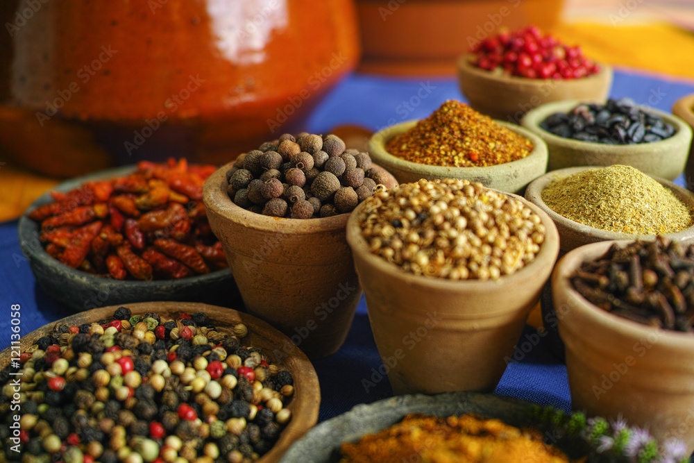 Collection of different spices in old clay bowls in colorful oriental style Collection of different spices in old clay bowls in colorful oriental style