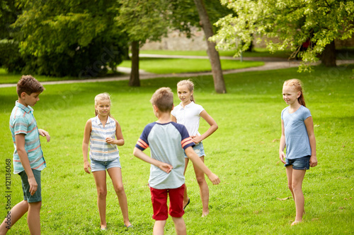 happy kids playing game in summer park