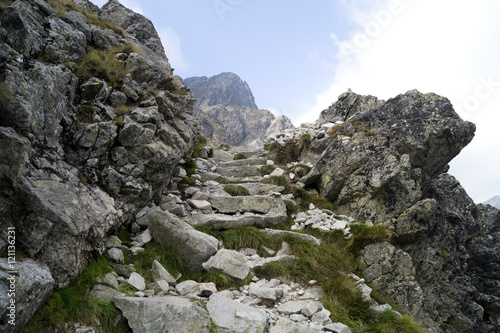 Red marked mountain trail. Stone stairs in difficult rocky terrain. Tatra Mountains. Slovakia