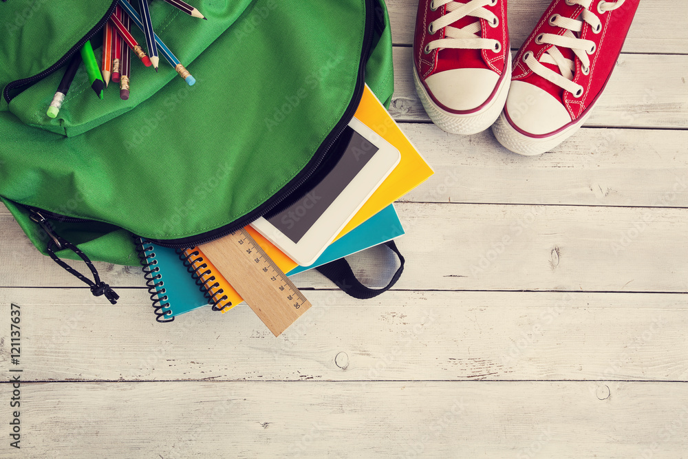 School backpack on wooden background - obrazy, fototapety, plakaty 