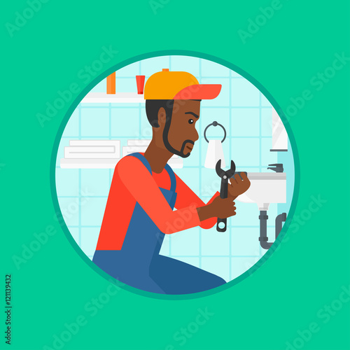 Plumber fixing sink pipe with wrench.
