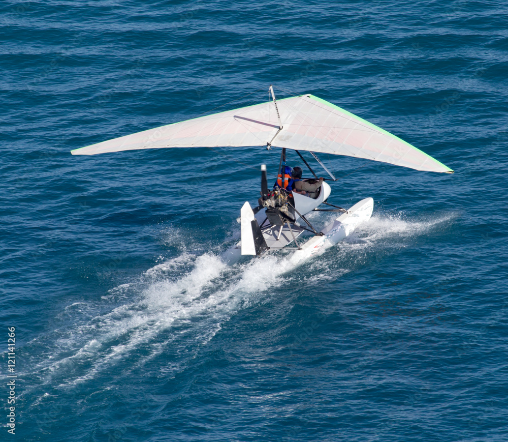 Naklejka premium plane takes off from the surface of the water