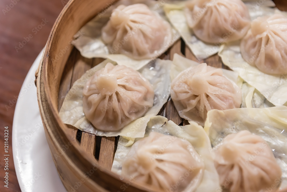 steamed mini pork buns with selective focus (xiao long bao) steamed mini pork buns with selective focus (xiao long bao)