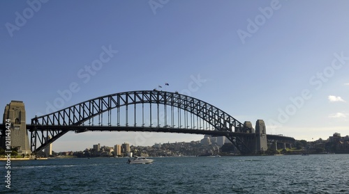 small motor boat passing by the Sydney Harbour bridge, Sydney NSW Australia  © skyf