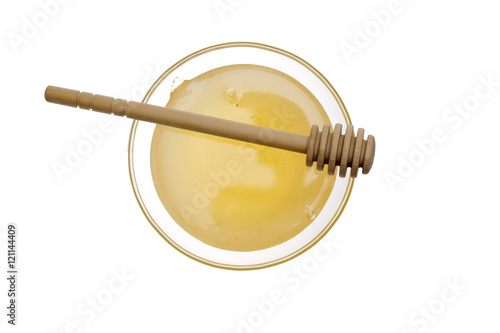 Bowl of honey and wooden honey sticker on white background.
