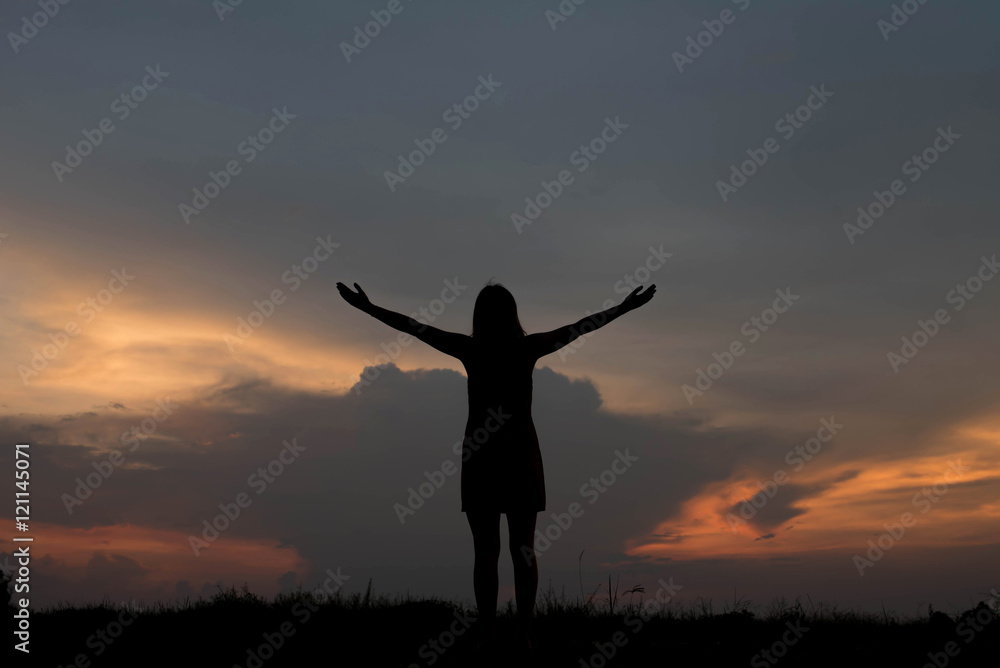 silhouette of woman happy alone at  sunset