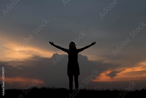 silhouette of woman happy alone at sunset