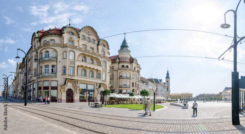 10 September 2016 - Oradea, Romania: Black Eagle Complex Palace ( Vulturul Negru ) in the Unirii Square of the city built in secession style and the tram lines running in front on the pedestrian area