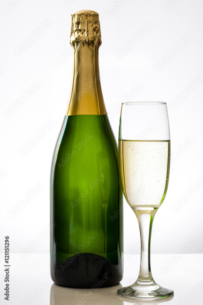 Champagne bottle with a glass cup on white background
Champagne bottle with a glass cup on white background