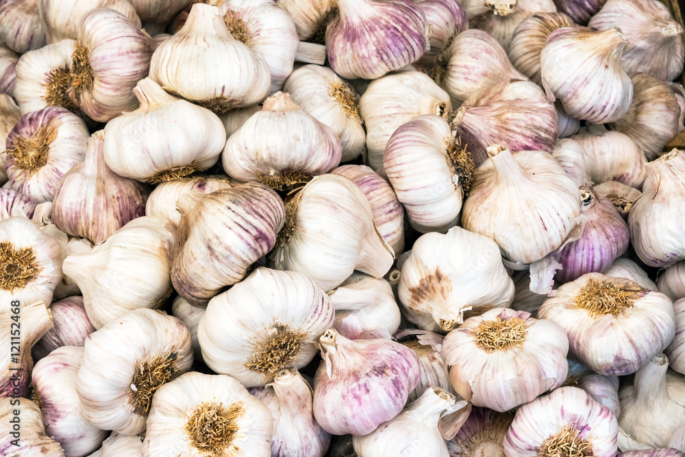 Fresh garlic bulbs for sale at a market Fresh garlic bulbs for sale at a market