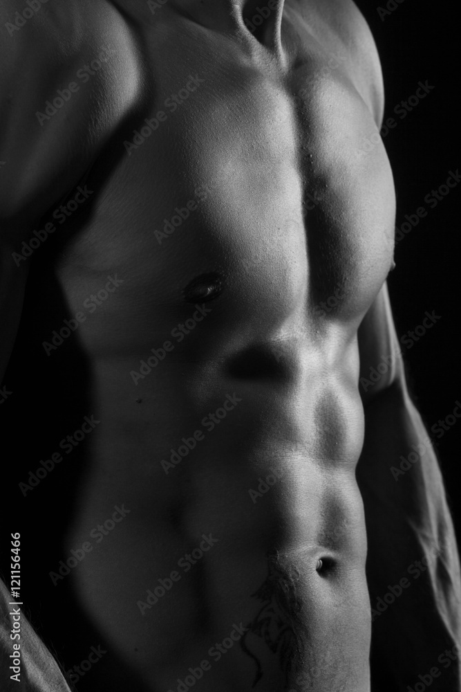 Muscular torso of young man black and white Muscular torso of young man black and white