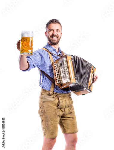 Man in bavarian clothes holding beer, playing accordion. Oktober