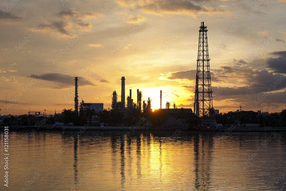 Petrochemical plant in night time with reflection over the river Petrochemical plant in night time with reflection over the river