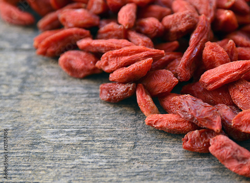 Dried goji berries close up on old wooden background.Goji berries background.Healthy food or diet concept. 
