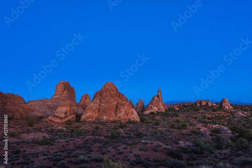 Blue hour sunset in Arches National Park with pink rock formations and plants