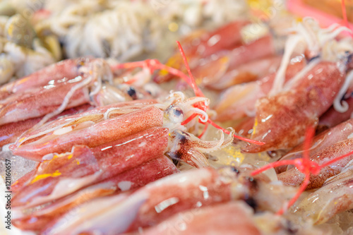 Seafood. Close up of fresh raw octopuses on the market.