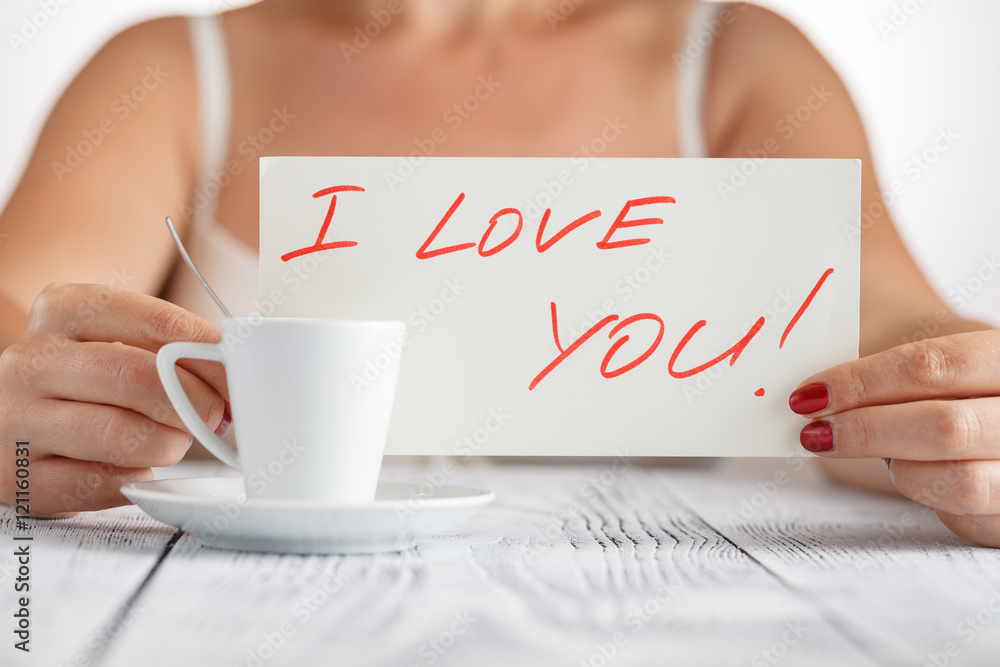 woman holding a paper message with the text I love you woman holding a paper message with the text I love you