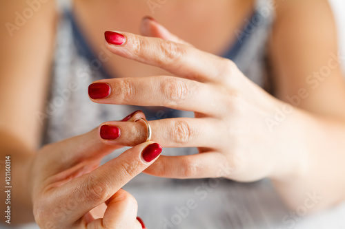 Woman is taking off the ring from hand