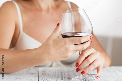 woman in bedroom with wine glass