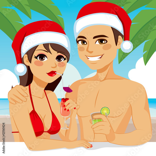 Young couple enjoying Christmas vacation drinking cocktail on tropical beach wearing Santa hat