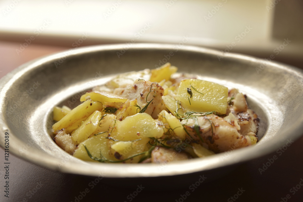 Zander fillet served with fresh potatoes on old plate Zander fillet served with fresh potatoes on old plate