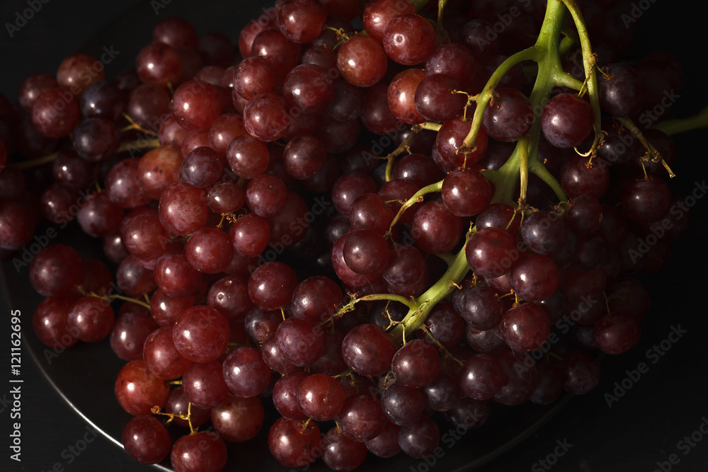 purple grapes still life on black background purple grapes still life on black background
