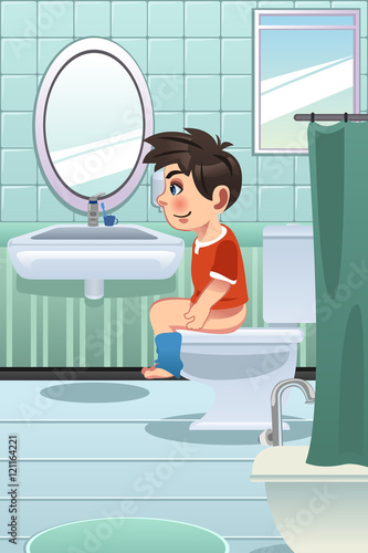 Boy Sitting on the Toilet in the Bathroom