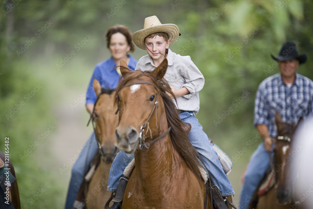 Family on horse trek through forest Family on horse trek through forest