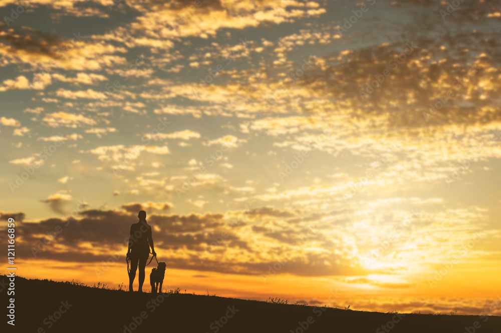 Girl with a dog at sunset.