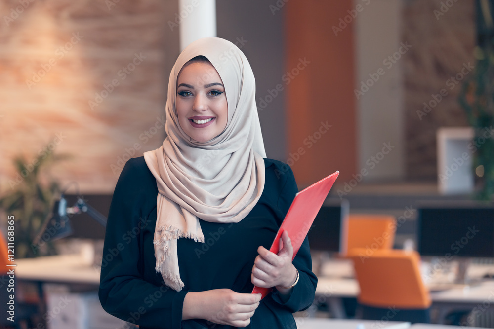 Arabian business woman holding a folder in modern startup office