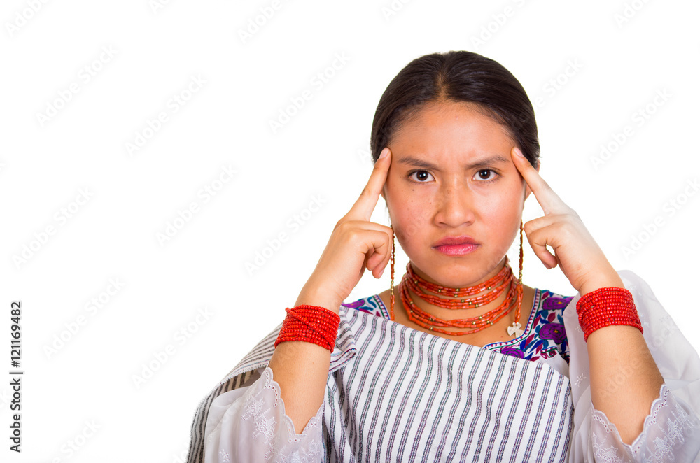 Headshot beautiful young woman wearing traditional andean shawl and red necklace, posing for camera using hands touching head interacting, white studio background Headshot beautiful young woman wearing traditional andean shawl and red necklace, posing for camera using hands touching head interacting, white studio background