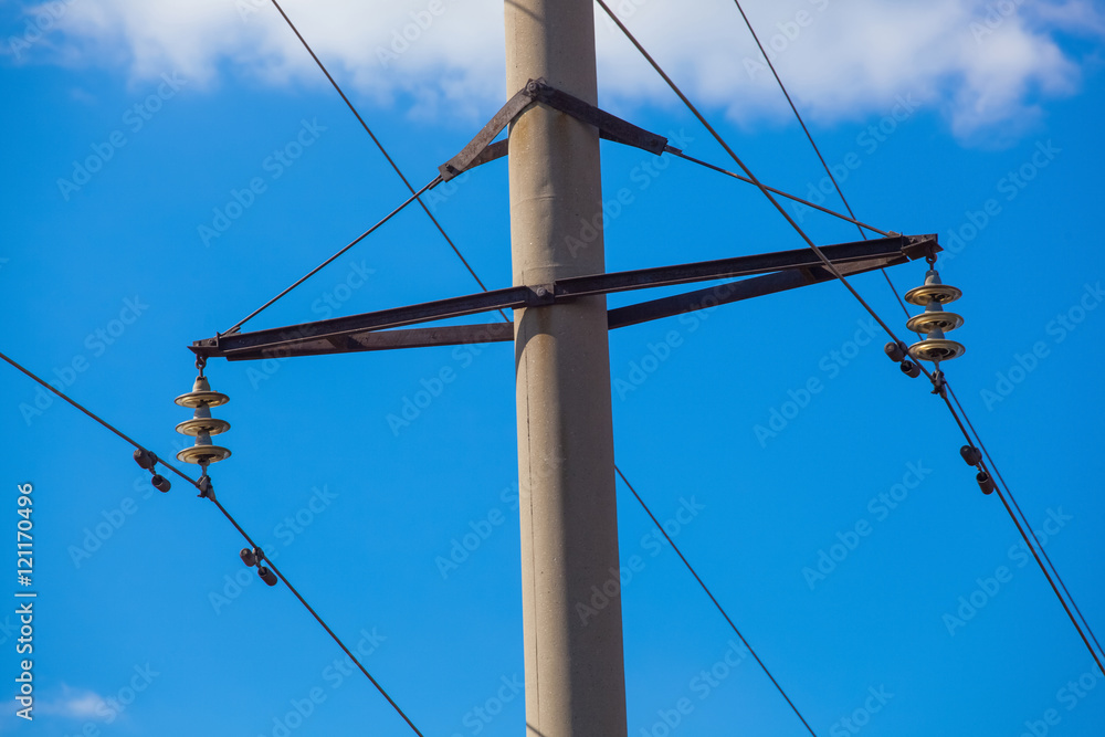 Intermediate transmission line costs against the sky close-up on a clear sunny day. power transmission by means of electric current.
