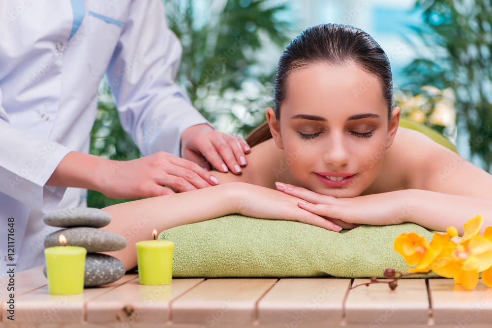 Young woman during massage session Young woman during massage session